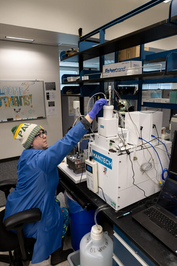 scientist working on a chemical analyzer