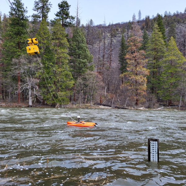 measuring equipment pulled by a yellow cableway system
