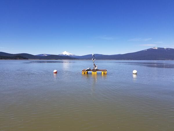floating platform on upper Klamath Lake. Blue sky over lake water with distant snow capped mountain