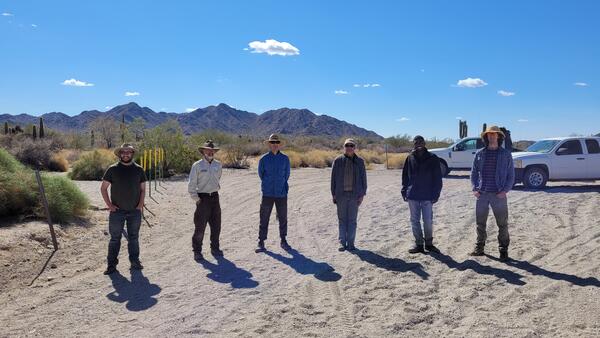 USGS and USFWS personnel stand in a line for a photo in the Cabeza Prieta National Wildlife Refuge desert, AZ