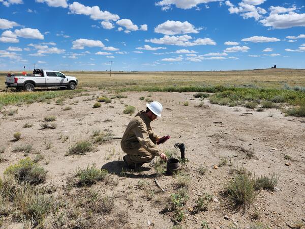 USGS Scientist taking a methane reading from an orphan well in Montana