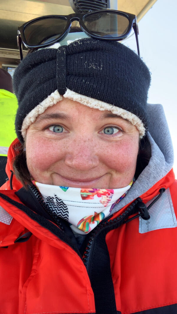 Researcher on a vessel wearing cold weather gear