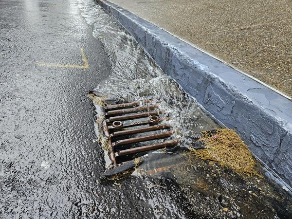 Water flows into drain in pavement