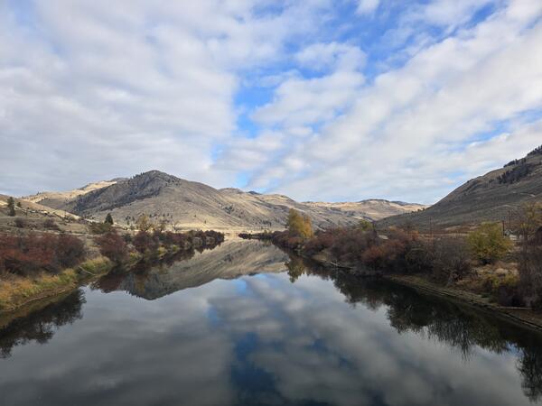 hills reflected in river