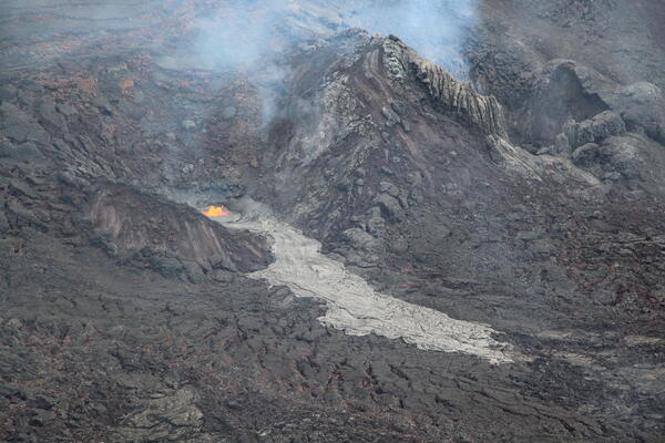 Color photograph of eruptive vent and lava flow