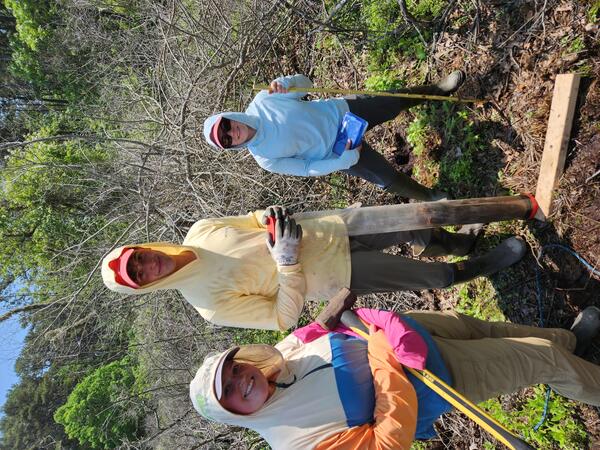 Interns smiling for a picture in a coastal wetland