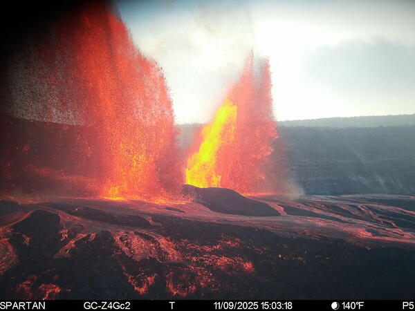 Color photograph of lava fountaining from two volcanic vents