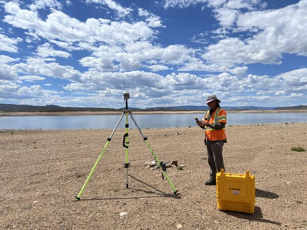 USGS remote pilot setting up instruments near the shore of Williams Fork Reservoir