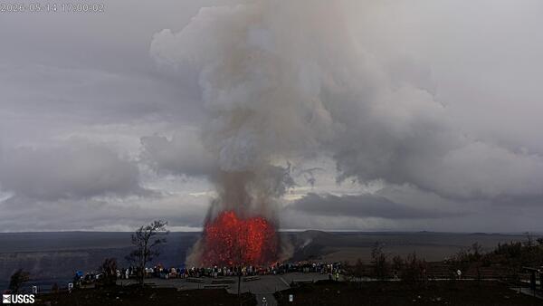 Color webcam image showing visitors at a National Park overlook viewing a lava fountain 