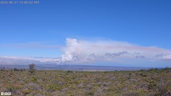 Color photograph showing volcanic plume in the distance