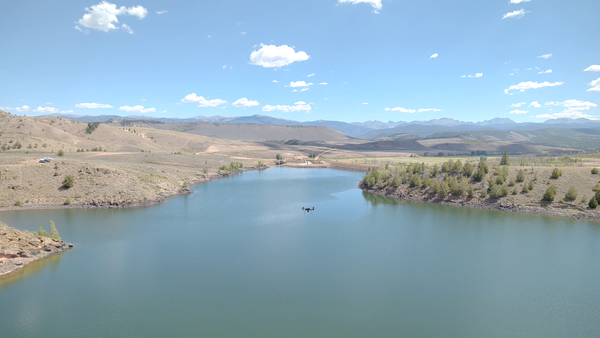 Overhead view of Willow Creek Reservoir, Colorado with drone craft flying above it.