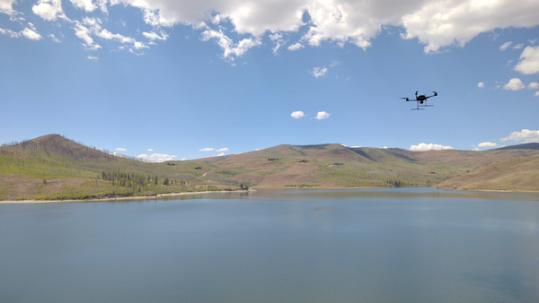 Drone aircraft flies above the surface of Willow Creek Reservoir
