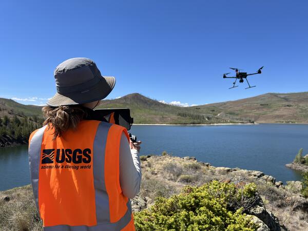 USGS drone pilot flies craft over reservoir