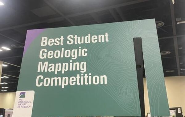 Large green rectangular sign reading "Best Student Geologic Map Competition"