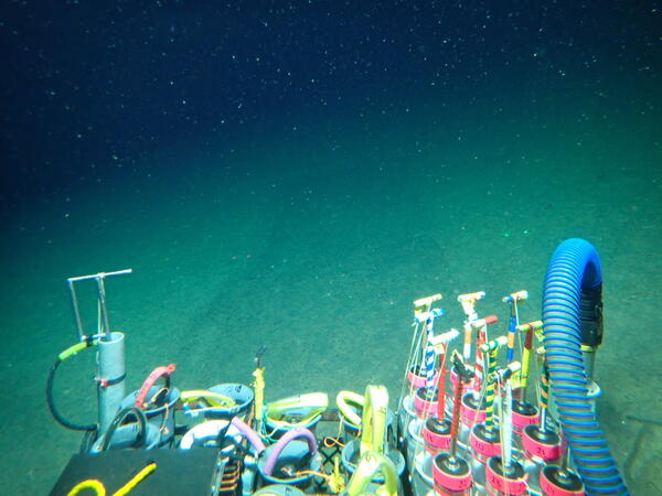 View from the Alvin showing mud and the devices to collect samples from the seafloor including cores
