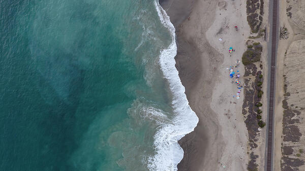 Photo showing aerial nadir view of a sandy shoreline in southern California