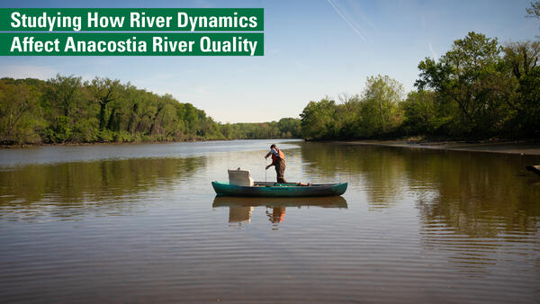 Photo of a hydrologic technician collecting a water sample from a canoe.
