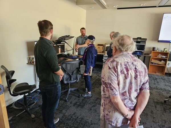 A USGS cartographer speaks to the public in the Photogrammetry Lab at the Flagstaff USGS Open House