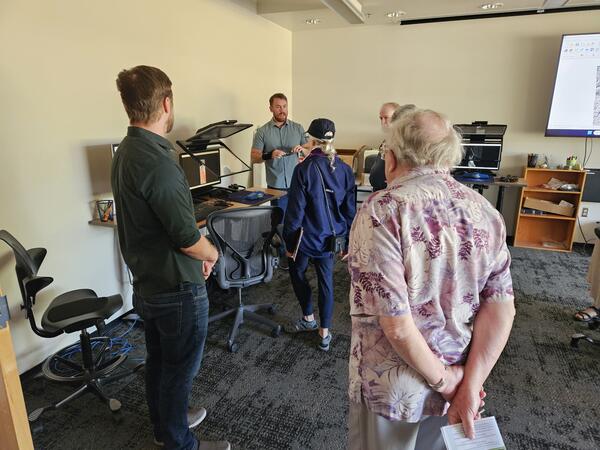 A USGS cartographer engages with the public in the Photogrammetry Lab at the USGS Flagstaff Open House