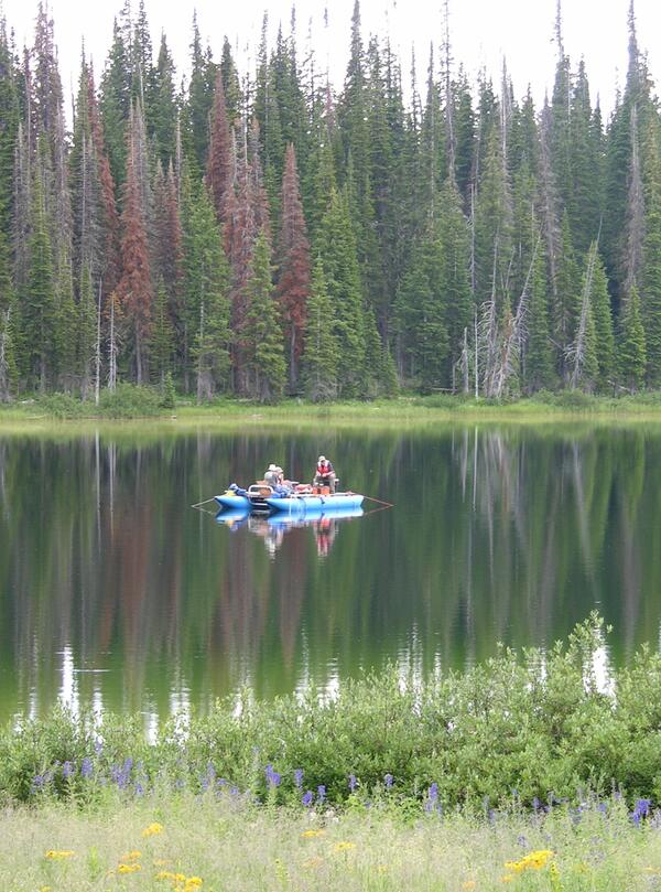 Scientists work on raft in a mountain lake in the White River Plateau, Colorado