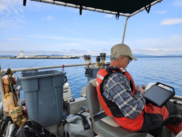 Man entering data on a boat