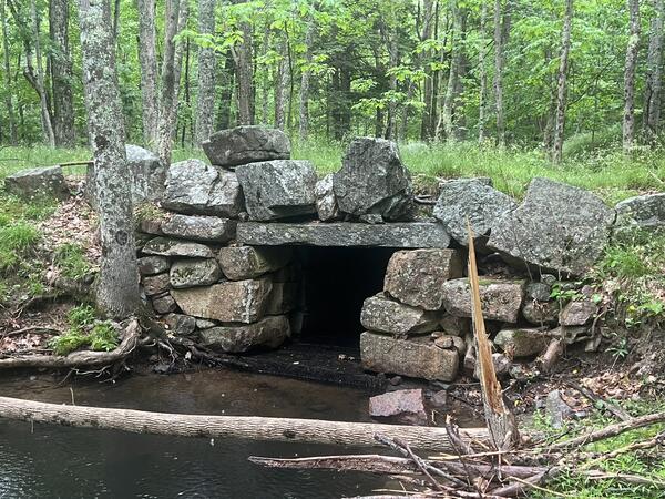 A culvert made with large boulders in a small stream.