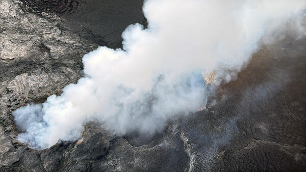 White volcanic gas plume being emitted from vents
