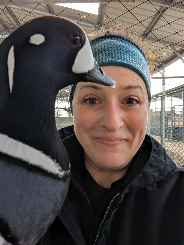 young woman wearing a headband holding a duck.