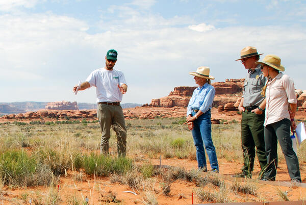A USGS scientist talks to National Park Service, BLM and a rancher about a grassland drought experiment in Canyonlands NP