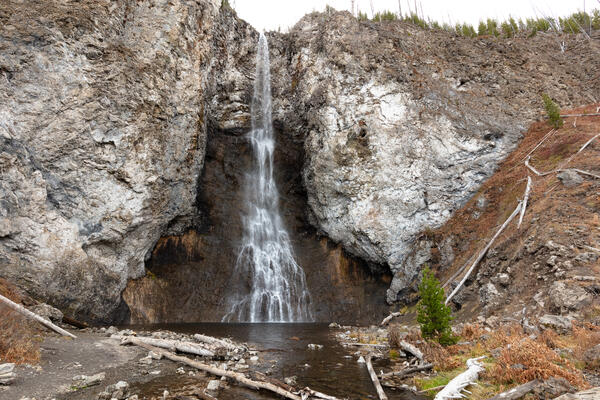 Thin waterfall cascading down a gray rock face
