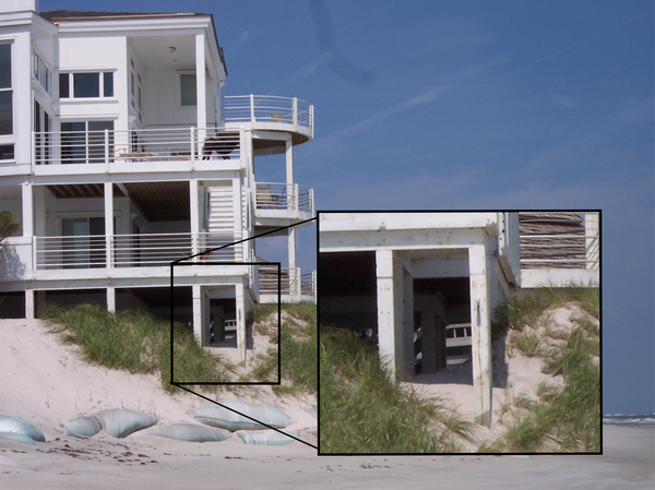 A beach home with exposed support columns at the edge of an eroded dune, Figure Eight Island, NC with inset