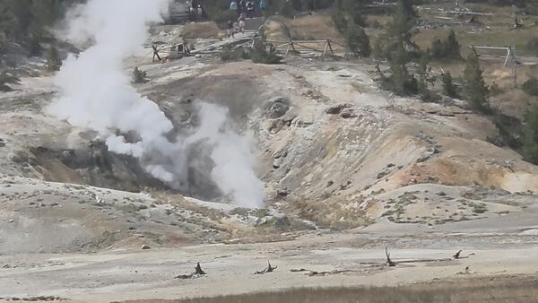 Barren hillside with steaming that marks the locations of two geysers