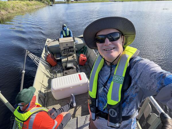 USGS crew stand and sit in a boat during the May 2026 Fish Slam