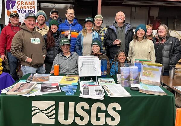 Grand Canyon Monitoring and Research Center staff at the USGS table during the Grand Canyon River Guides training, 2024