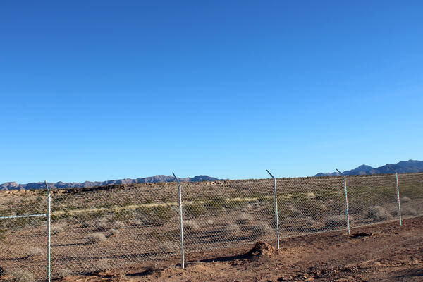 A fenceline at the Gemini Solar Project is raised a few feet off the ground to allow some wildlife passage