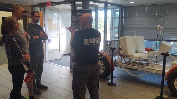 Greg Vaughn at USGS Astrogeology talks to visitors at the 2023 USGS Open House
