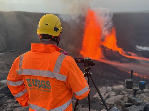 Color photograph of scientist monitoring eruption