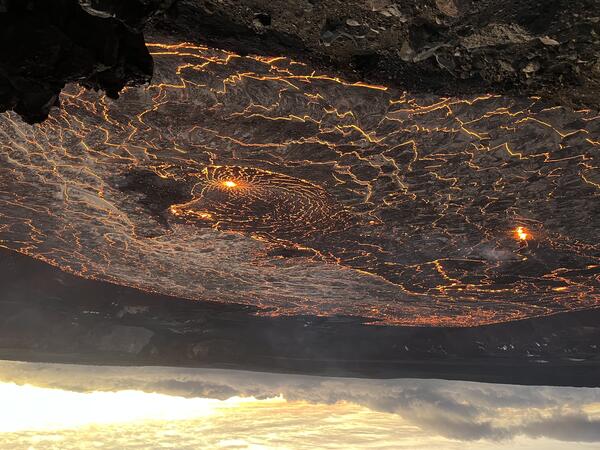 Color photograph of molten lava lake glowing