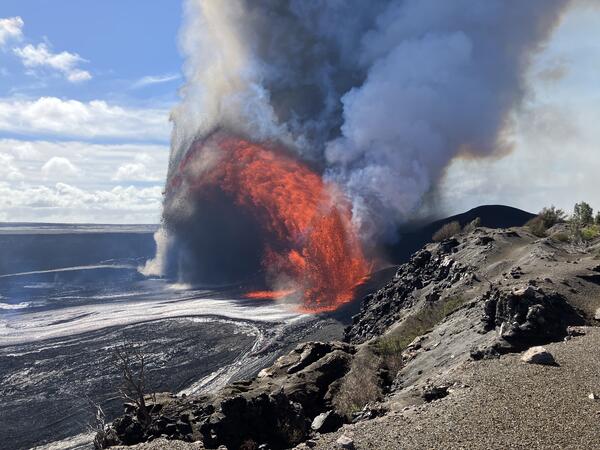 Color photograph of lava fountaining within volcanic crater