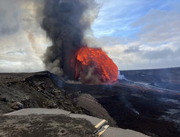 Color photograph of lava fountaining and road