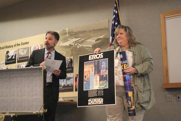 two people presenting a poster