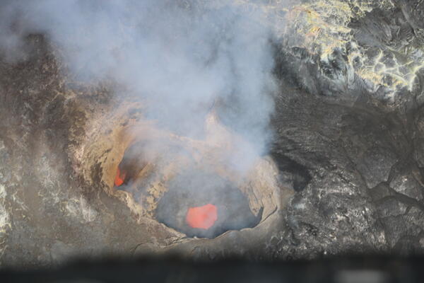Color photograph of molten material within volcanic vent