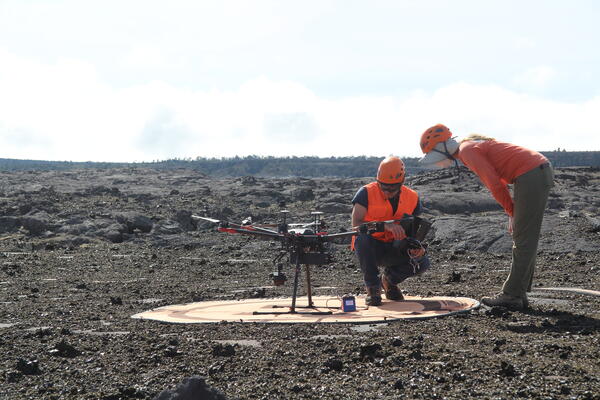 Color photograph of two scientists inspecting UAS