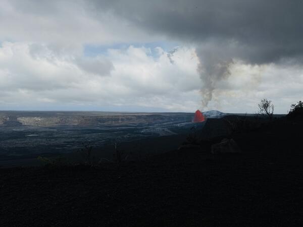 Color photograph of lava fountain within volcanic crater