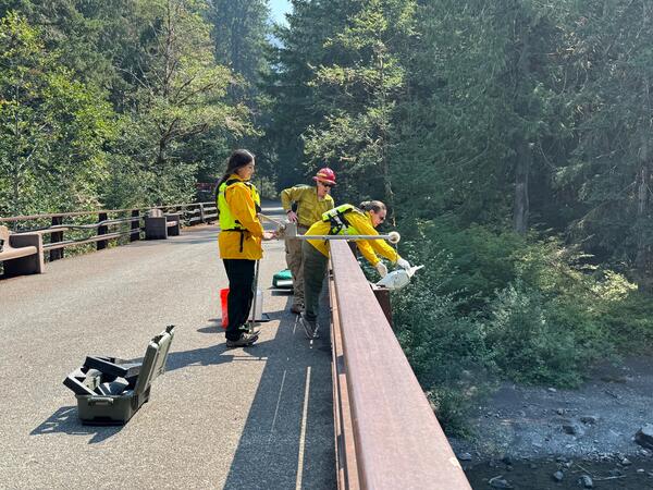 Scientists collect water sample from bridge