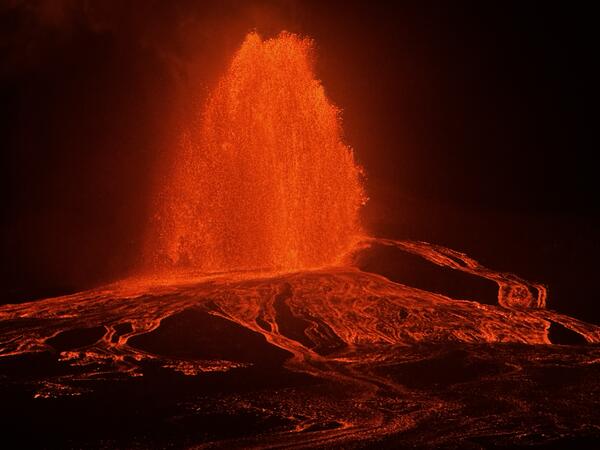 Color photograph of lava fountain at night