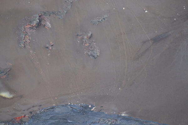 Color photograph of rock slides down a steep slope