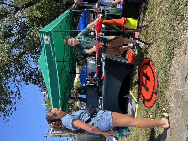 person showing drone to another person outside