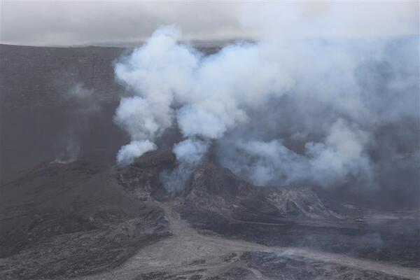 Color photograph of inactive volcanic vent that is degassing