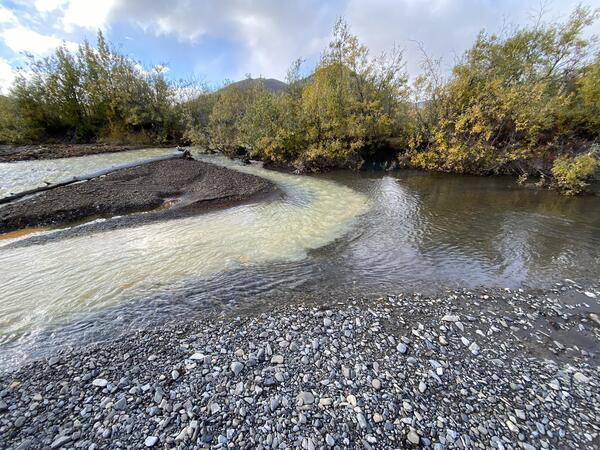 A pale orange and clear blue river mixing.